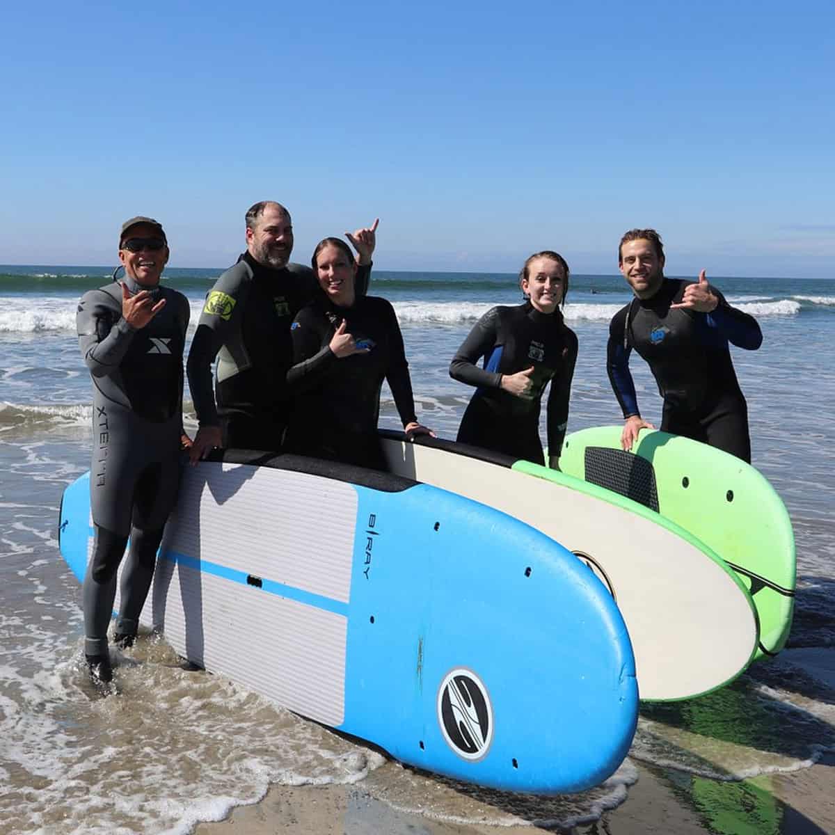 Surf instructor guiding beginners during a San Diego surfing session