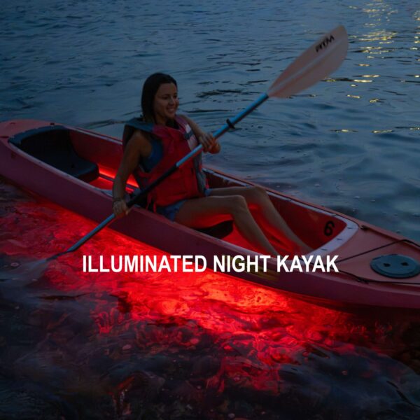 MVI_0263-2 Guests paddling illuminated kayaks through calm tropical waters at night