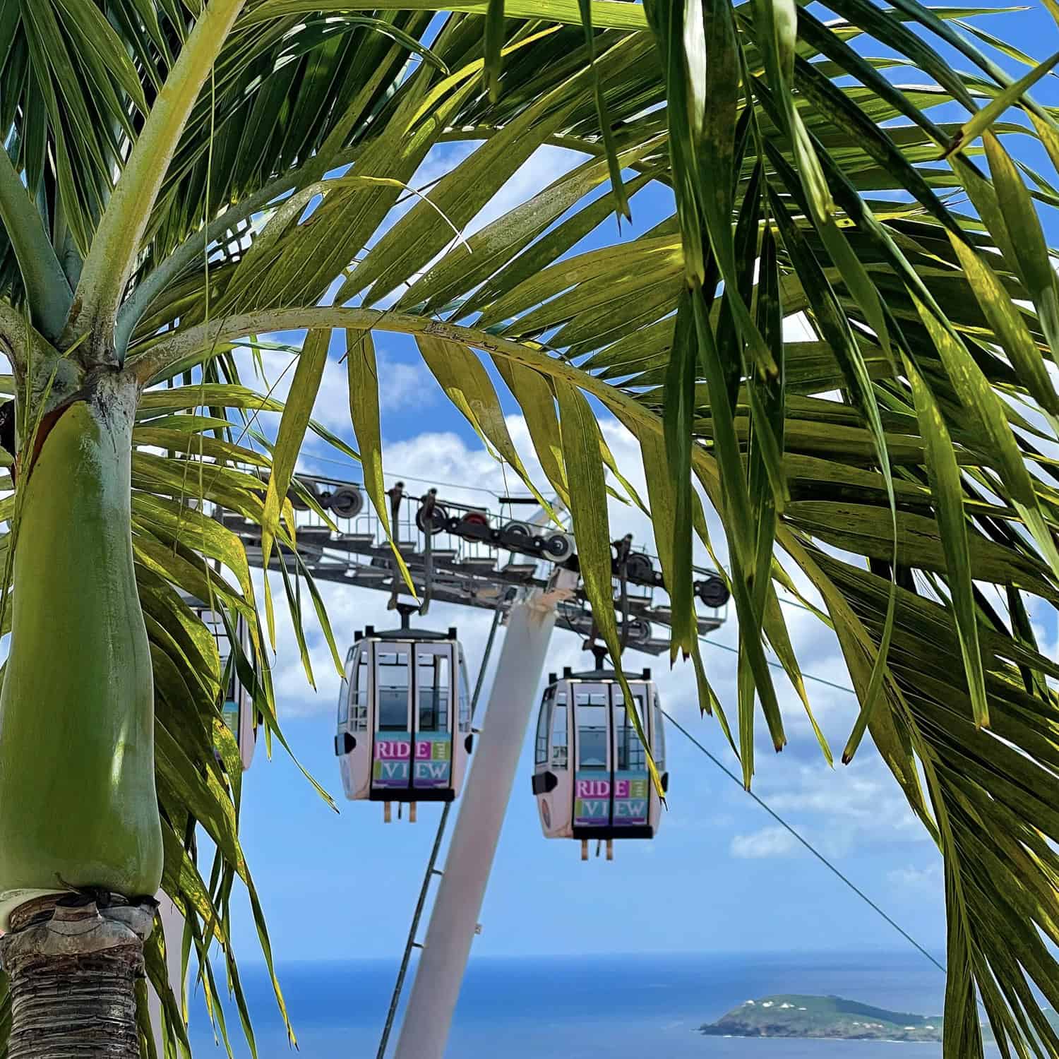Guests riding the Skyride to Paradise Point while overlooking the turquoise Caribbean Sea.